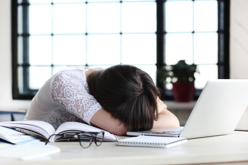 A person sleeping at a desk